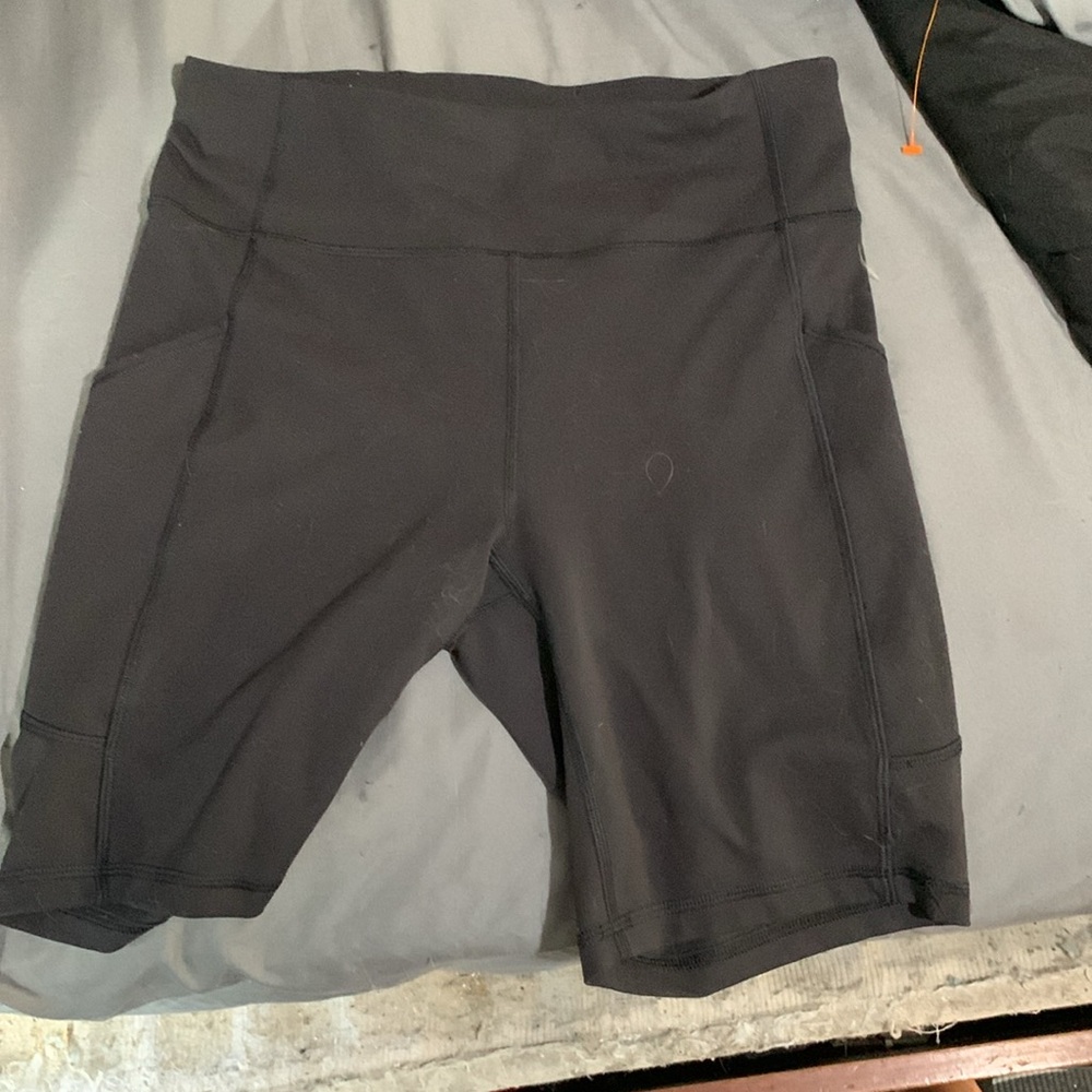 Lululemon size 8 black biker shorts with pockets and adjustable string.